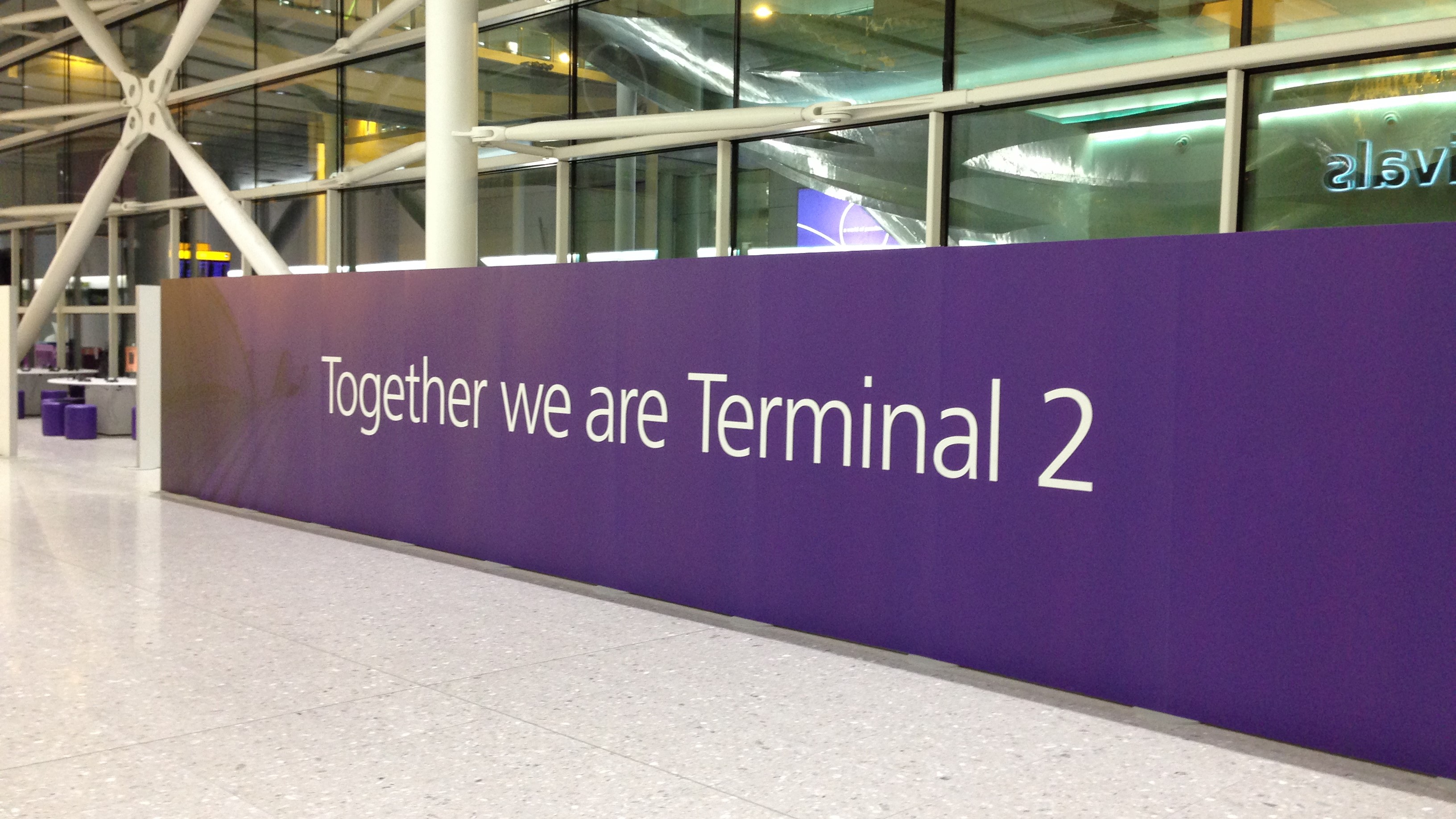 Terminal 2 arrivals with 'Together we are Terminal 2' banner
